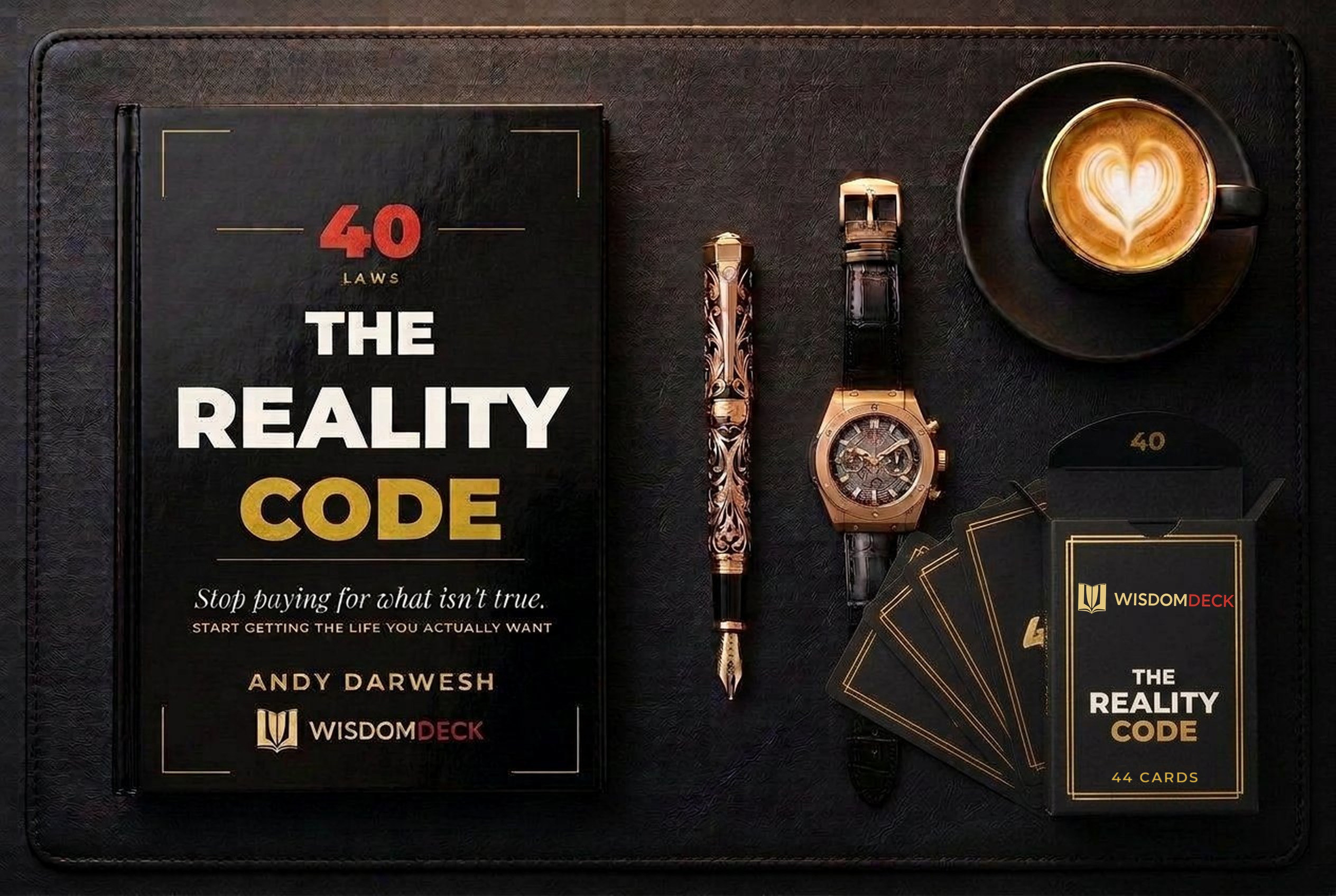 The Reality Code laid flat on a desk with a fountain pen, watch, coffee, and the 44-card companion deck in its tuck box